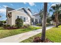 Beautifully landscaped home with a well-maintained lawn and inviting walkway, complemented by mature trees at 7845 Dausset St, Orlando, FL 32827