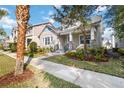 Beautifully landscaped home with a well-maintained lawn and inviting walkway, complemented by mature trees at 7845 Dausset St, Orlando, FL 32827