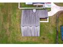 Aerial view of the roof, manicured lawn, and surrounding neighborhood at 820 E Flag Ln, Kissimmee, FL 34759