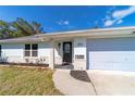 Inviting front entrance with brick accents, new landscaping, and a modern door with glass detail at 820 Rayston, Deltona, FL 32725