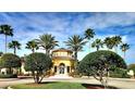 Beautiful Villanova clubhouse, surrounded by mature landscaping and palm trees at 12204 Wild Iris Way # 109, Orlando, FL 32837