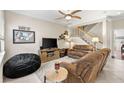 Comfortable living room with natural light and a staircase leading to the second floor at 13221 Fountainbleau Dr, Clermont, FL 34711