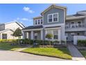 Two-story townhome featuring well-maintained landscaping and a sidewalk leading to the entrance at 14031 Centerline Dr, Orlando, FL 32827