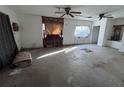 Bedroom with a large window, natural light, and bare flooring at 15700 Se Highway 42, Weirsdale, FL 32195