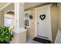 Welcoming front porch with a decorative wreath, 'Welcome to our Porch' sign, and inviting decor at 1602 Pine Ridge Dr, Davenport, FL 33896