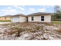 Picture of a quaint one-story house with a convenient two-car garage, surrounded by lush greenery at 195 Maple Dr, Kissimmee, FL 34759