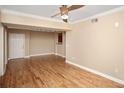 Open living room with hardwood floors, ceiling fan, and view into the kitchen at 206 E South St # 4031, Orlando, FL 32801