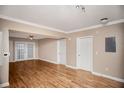 Well-lit living room boasting hardwood floors, ceiling fan, and access to the balcony at 206 E South St # 4031, Orlando, FL 32801