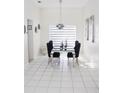 Bright dining room featuring modern chandelier, stylish table set, and white tile flooring at 2324 Merrimack Dr, Kissimmee, FL 34743