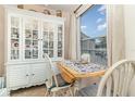 Cozy breakfast nook featuring a china cabinet, a small dining table, and a picturesque window view at 2552 Woodgate Blvd # 204, Orlando, FL 32822