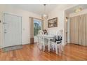 Bright dining room with hardwood floors, a pendant light, and a view to the bathroom at 2552 Woodgate Blvd # 204, Orlando, FL 32822