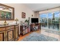 Cozy living room with water view, elegant furnishings, and a sliding glass door to the outside at 2552 Woodgate Blvd # 204, Orlando, FL 32822