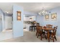 Cozy dining room with table, chairs, chandelier, and access to the modern kitchen at 325 Wilder Blvd # A404, Daytona Beach, FL 32114