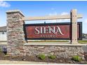 An attractive stone and wood sign welcomes residents to the Siena Reserve community at 5593 Vigo Loop, St Cloud, FL 34771