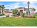 Charming home featuring a paver driveway, lush lawn, manicured landscaping, and a welcoming front porch at 719 Postrio Way, Ocoee, FL 34761