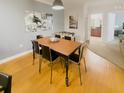 Inviting dining area with hardwood floors, seamlessly connected to an open-concept kitchen at 8010 Tuscany Way # 5206, Davenport, FL 33896