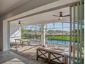 Expansive screened patio offering a pool view, dining area, cozy seating, and seamless transition to indoor living space at 8903 Caroline Bay Ct, Kissimmee, FL 34747