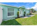 Charming home featuring a white front door with decorative plants and a well-manicured lawn at 905 Bella Vista Way, Orlando, FL 32825