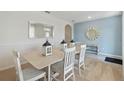 Bright dining room with a stylish mirror and decorative elements, perfect for Gathering meals and entertaining at 915 Princess Sabal Pt, Haines City, FL 33844