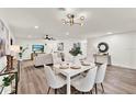 Bright living room with a white brick wall, modern decor, wood flooring, and a dining area at 921 W Lake Brantley Rd, Altamonte Springs, FL 32714