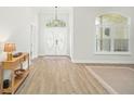 Bright entryway features wood floors, a decorative door, and natural light at 10361 Mallard Landings Way, Orlando, FL 32832