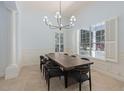 Elegant dining room with a large window, modern chandelier, and seating for eight, perfect for entertaining at 11237 Camden Park Dr, Windermere, FL 34786