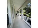 Inviting covered porch with white columns and railings offers a relaxing outdoor space at 11474 Claymont Cir, Windermere, FL 34786