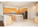 Bright kitchen featuring stainless steel appliances, tile flooring, and island with seating at 11474 Claymont Cir, Windermere, FL 34786