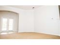 Spacious room with carpet, arched doorway, and French doors to lanai at 11474 Claymont Cir, Windermere, FL 34786