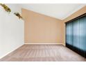 Empty living room featuring plush carpeting, neutral walls, and a tall window for plenty of natural light at 1341 American Elm Dr, Altamonte Springs, FL 32714