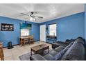 Comfortable living area featuring bright blue walls, tile flooring, a cozy couch and streaming tv at 1417 Independence Ave, Deltona, FL 32725