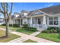 Beautiful townhouse with a well-kept lawn, elegant landscaping, and a welcoming front porch at 14472 Chinese Elm Dr, Orlando, FL 32828