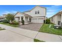 Charming two-story home featuring a well-manicured lawn and a welcoming front porch with stone detailing at 1472 Rushing Rapids Way, Winter Springs, FL 32708
