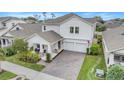 Aerial view of a two-story home with a brick driveway, well-maintained landscaping and a cozy front porch area at 1472 Rushing Rapids Way, Winter Springs, FL 32708