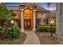 Elegant home entrance with double doors, manicured landscaping, and inviting walkway at 210 Torcaso Ct, Winter Springs, FL 32708