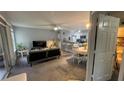 Cozy living room featuring open access to a modern kitchen and plenty of natural light at 2200 Metropolitan Way # 926, Orlando, FL 32839