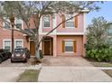 Charming townhome featuring a well-maintained exterior and a private brick driveway at 2336 Caravelle Cir, Kissimmee, FL 34746