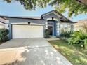 Inviting single-story home with blue exterior, two car garage, and lush landscaping, perfect for families at 4020 Shawn Cir, Orlando, FL 32826