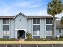 Exterior view of condominium complex featuring modern design, palm trees, and well-maintained landscaping at 4705 S Texas Ave # 4705D, Orlando, FL 32839