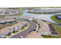 Aerial view of a community with water views, manicured landscaping and convenient parking at 4844 Romeo Cir, Kissimmee, FL 34746