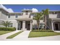 Beautiful townhome featuring a tile roof, well-maintained landscaping, and covered entryway at 4844 Romeo Cir, Kissimmee, FL 34746