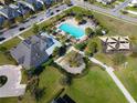 Overhead shot of the community pool and recreational area with palm trees and playground at 5023 Southlawn Ave, Orlando, FL 32811