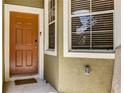 Inviting front door with sidelight window and modern hardware, set in a neutral-toned exterior at 5150 Fiorella Ln, Sanford, FL 32771
