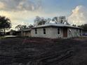 An unfinished block home featuring a new roof and modern windows, in a neighborhood setting at 5238 2Nd St, Orlando, FL 32810