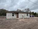 An unfinished block home with a new roof and modern windows set on a level lot at 5238 2Nd St, Orlando, FL 32810