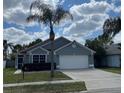 A charming single-story home featuring a well-manicured front yard and attached two-car garage at 636 Bohannon Blvd, Orlando, FL 32824