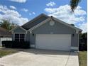 A single-story home with an attached two-car garage and well-maintained landscaping at 636 Bohannon Blvd, Orlando, FL 32824