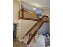 Inviting staircase with wood banister, carpeted steps, and views of the living area at 6630 Abeydon Ct, Orlando, FL 32818