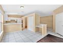 Open kitchen with white cabinetry and breakfast bar overlooking the dining area at 11223 Huxley Ave, Orlando, FL 32837