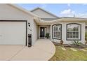 Charming single-story home featuring a well-maintained lawn, two-car garage, and an inviting front entrance at 116 Douglas St, Edgewater, FL 32141
